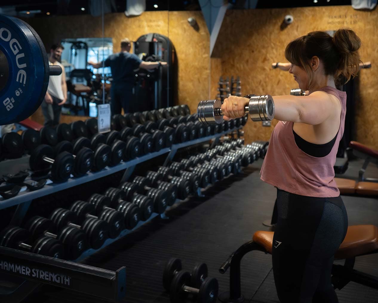 Woman doing a lateral raise in the gym